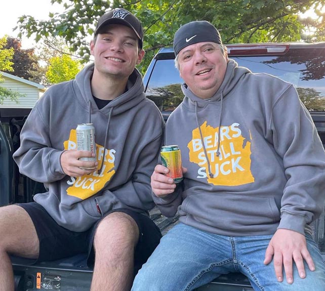 Matt Ramage and his son drinking beer wearing Bears Still Suck hoodies.